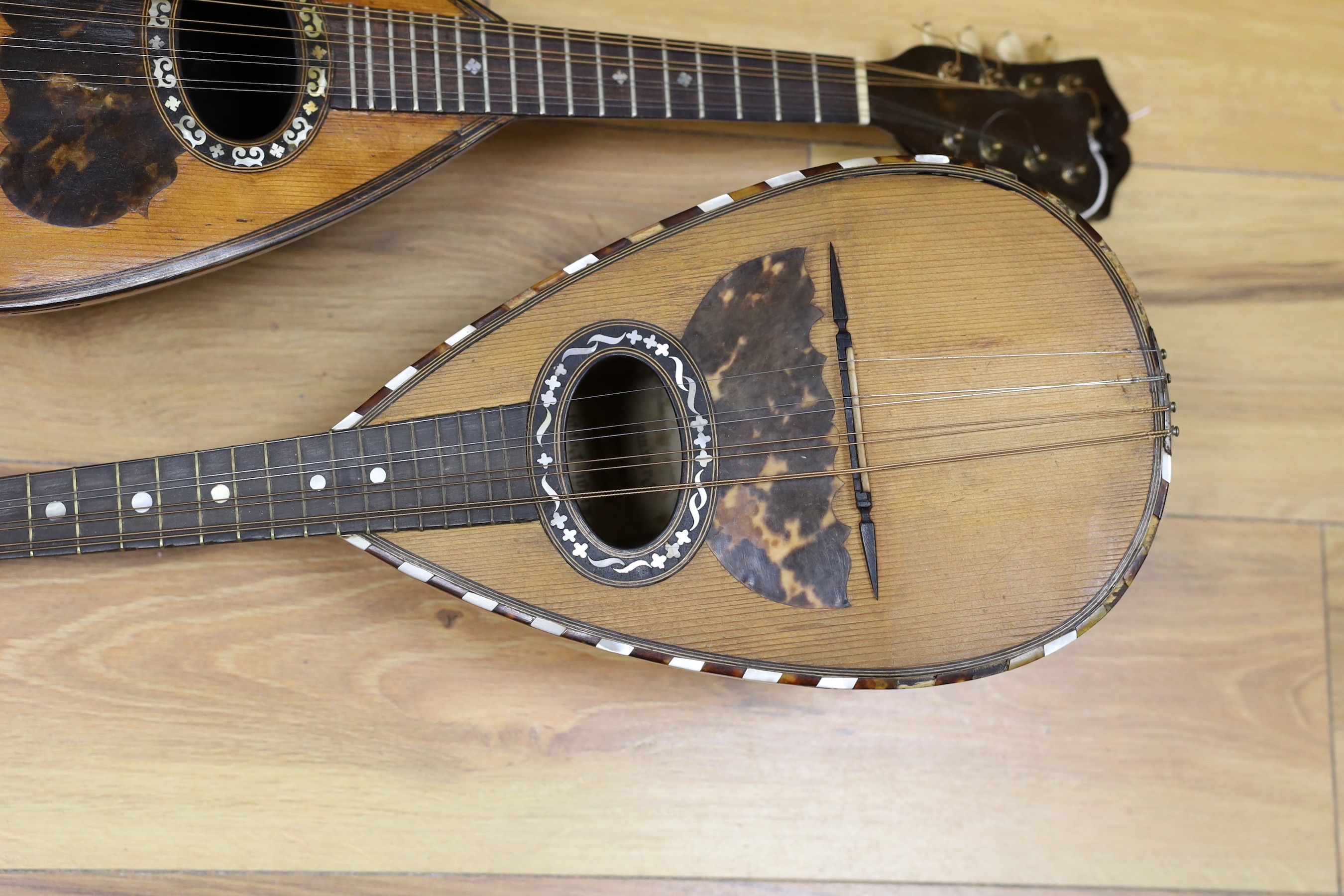 Two mandolins, with mother of pearl and tortoiseshell inlay, 57ms long, bone mounts